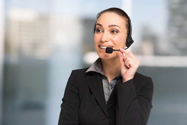 Customer service concept, businesswoman talking to a customer using an headset