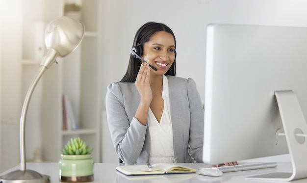 Customer service consultant and contact support by call center agent talking to a customer on video call Happy employee enjoying online customer care while working on guidance and advice in office