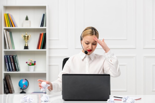 Customer service cute blonde girl office shirt with headset and computer tired