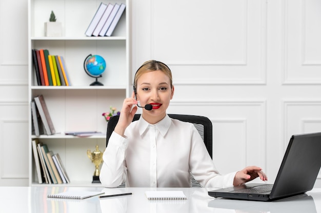 Customer service cute girl in white shirt with red lipstick and laptop on the headset