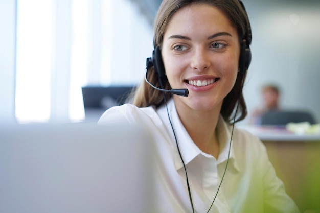 Customer support operator working in a call center office.