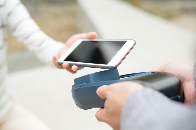 Customer using mobile phone to pay