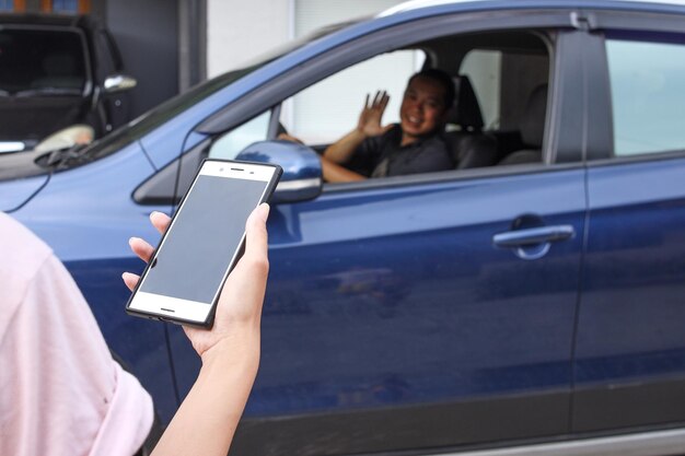 Customer waiting driver to pick up on city street Mobile and online booking for online taxi