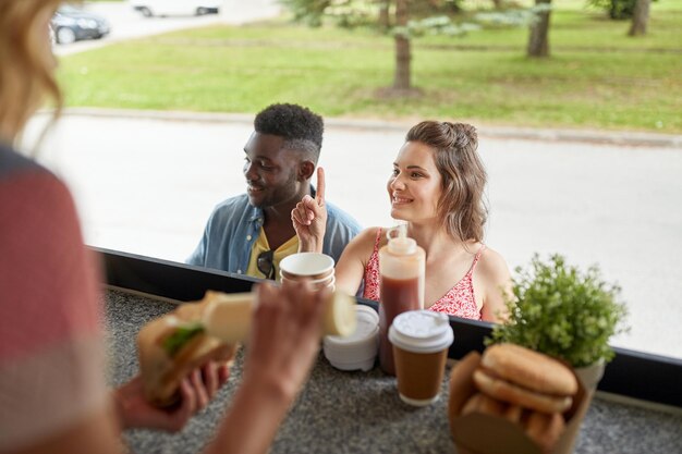 Photo customers couple ordering hamburgers at food truck