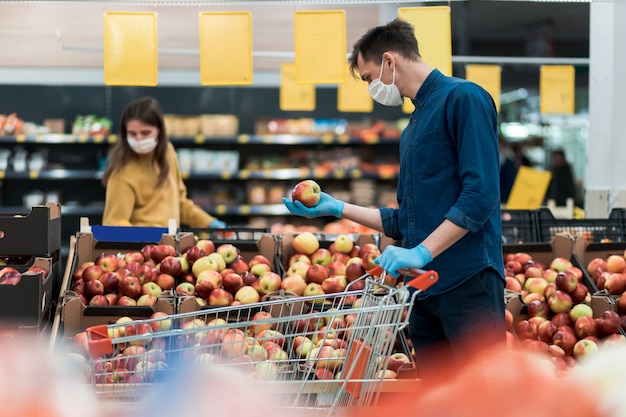 Customers wearing protective masks keep their distance during the quarantine period. photo with a copy of the space