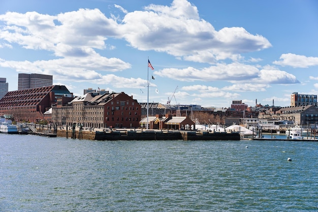 Customhouse at Boston Wharf across Charles river with the skyline of the city in the background in Boston, America