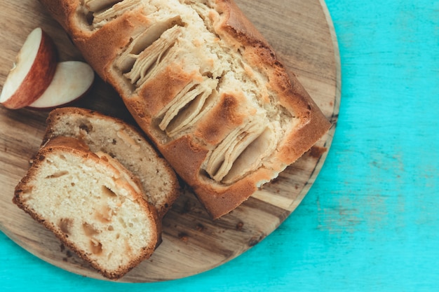 Cut apple cake on a blue background. copy space. baking concept.