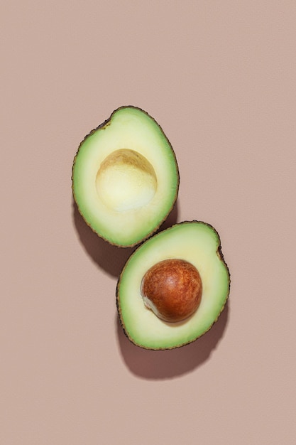 cut avocado on beige background