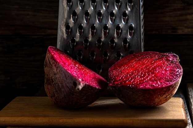 Cut beetroot on a cutting board against the background of a grater Home kitchen