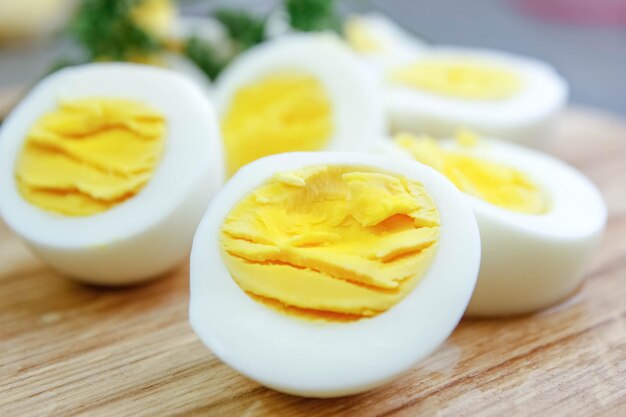 cut boiled eggs on a wooden board in the kitchen