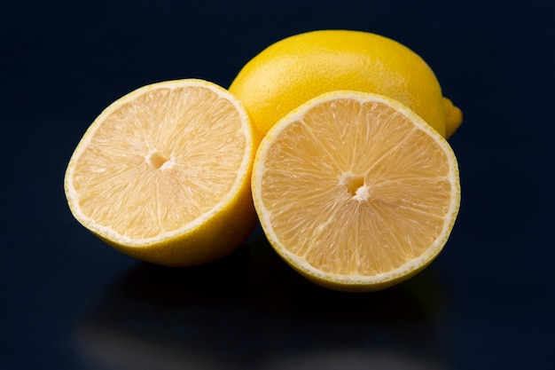 Cut citrus fruit of lemon on blue