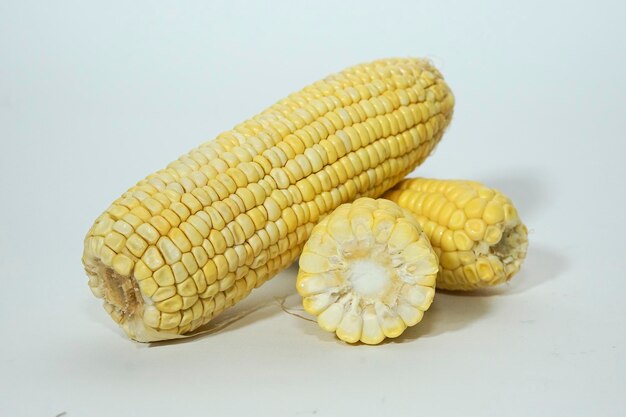 Cut fresh sweet corn isolated on white background