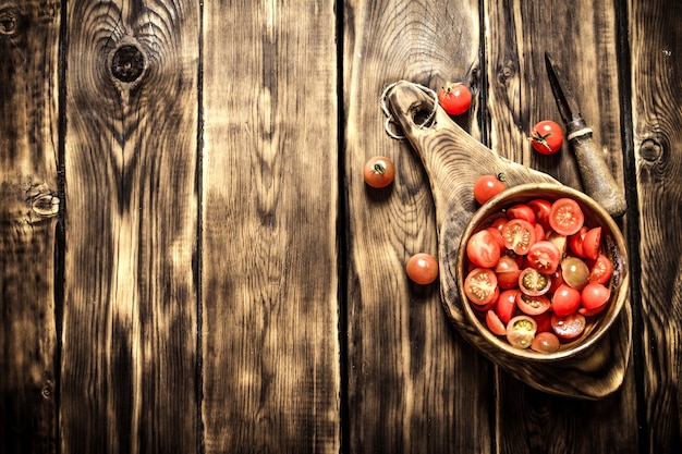 Cut fresh tomatoes in a wooden bowl