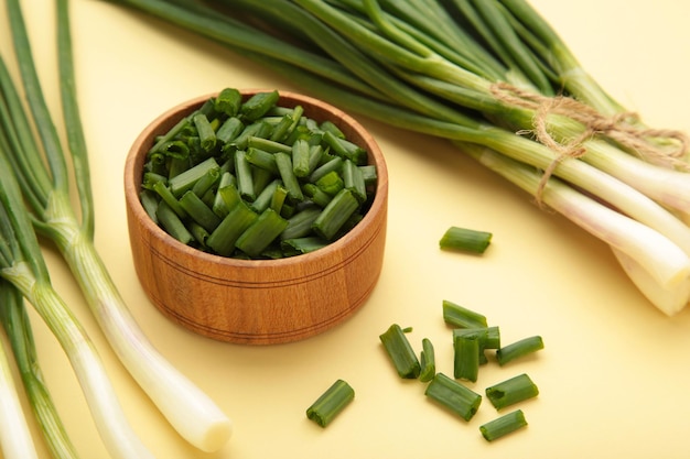 Cut green onion on a beige background