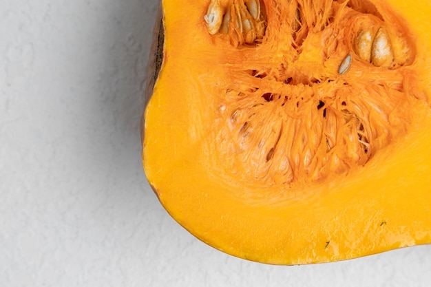 Cut in half pumpkin on a white background close up