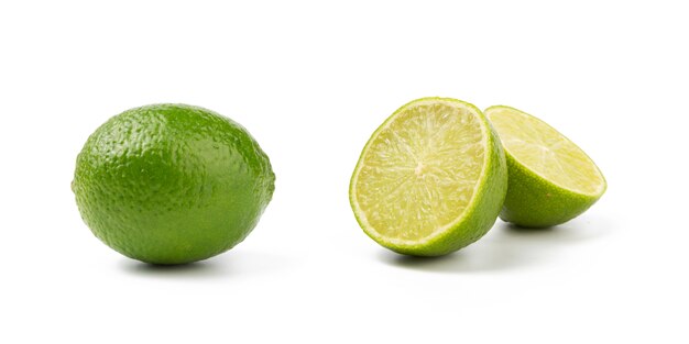 Photo cut to halves and whole lime isolated on white background