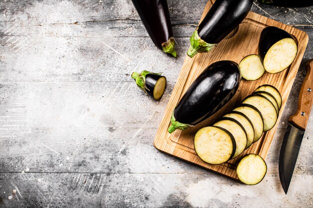 Cut into pieces of ripe eggplant on a wooden cutting board