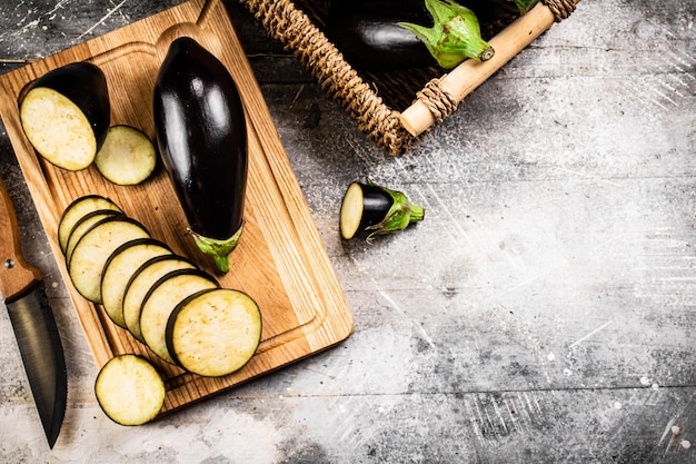 Cut into pieces of ripe eggplant on a wooden cutting board