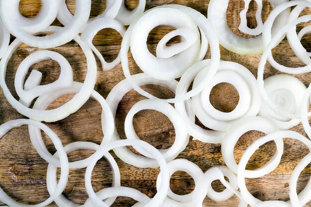 Cut into pieces sour onions, cutting Board on which the ingredients for the salad are prepared, closeup of the cut onion