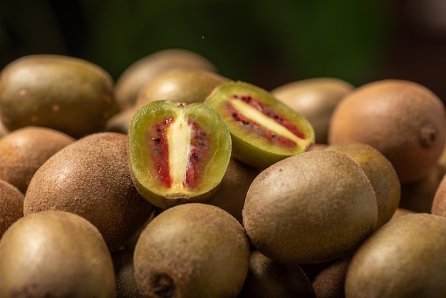 The cut kiwi fruit is placed on a plate on a wooden table