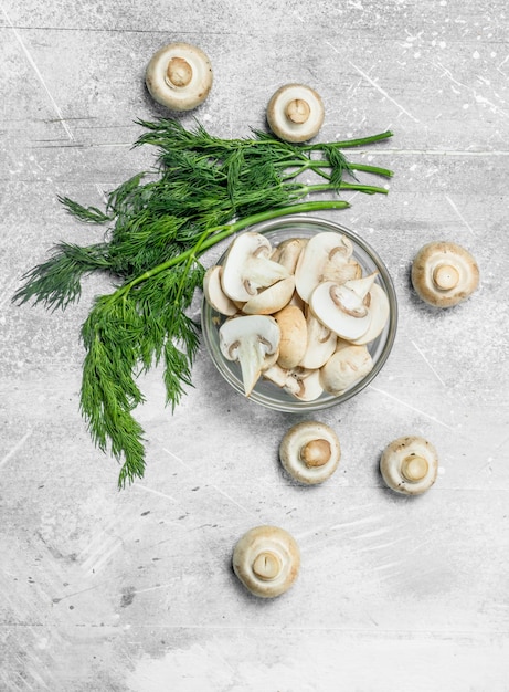 Cut mushrooms in a bowl with greens