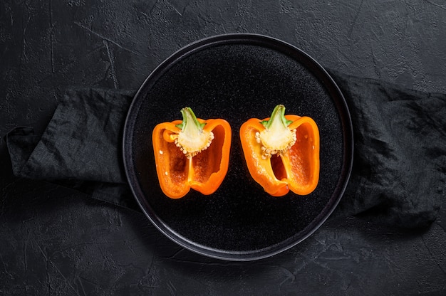 Cut orange bell pepper, two halves.