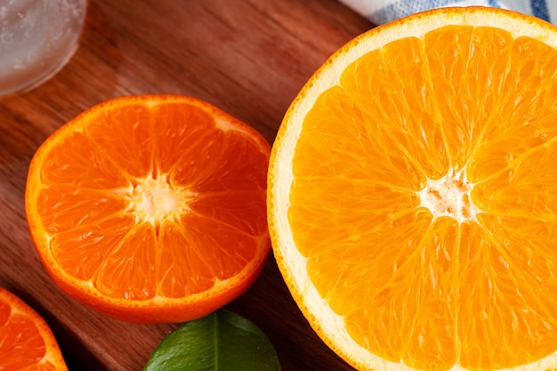 Нарезать апельсины на деревянной доске на столе