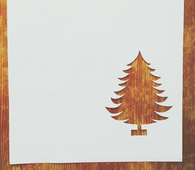 cut paper in christmas tree shape on table