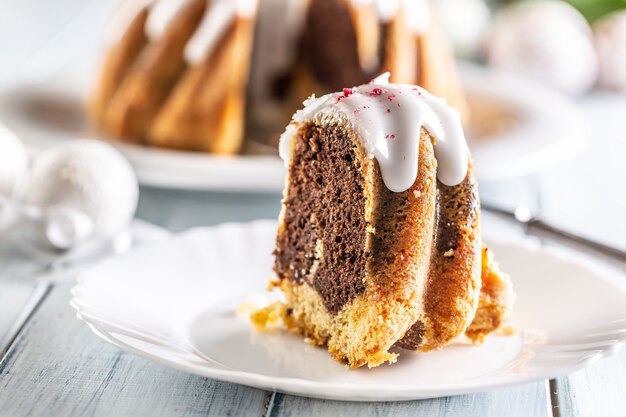 A cut piece of Easter marble cake on a white plate.