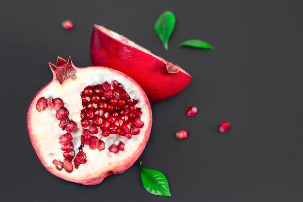 cut pomegranate on a black background close up