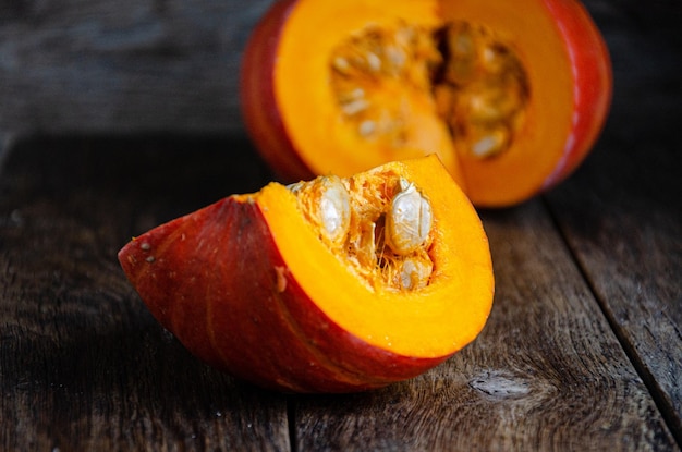 Cut pumpkin on a wooden table. Cooking in the kitchen.