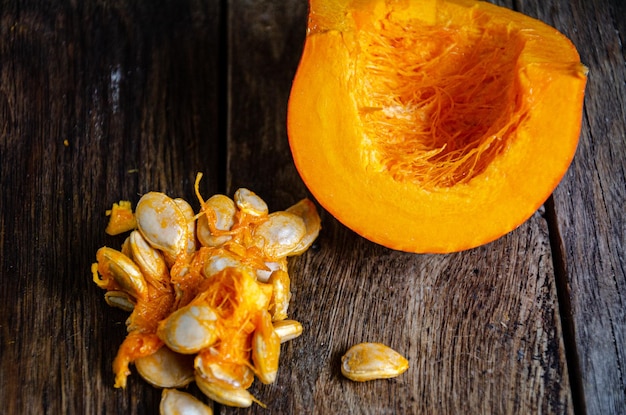 Cut pumpkin on a wooden table. Cooking in the kitchen.