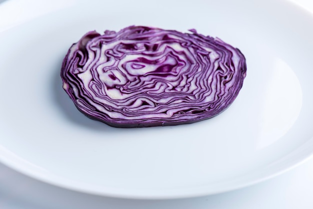 Cut of red cabbage on the white plate