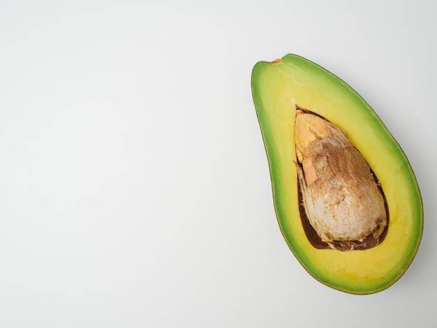 Cut ripe avocado on white background