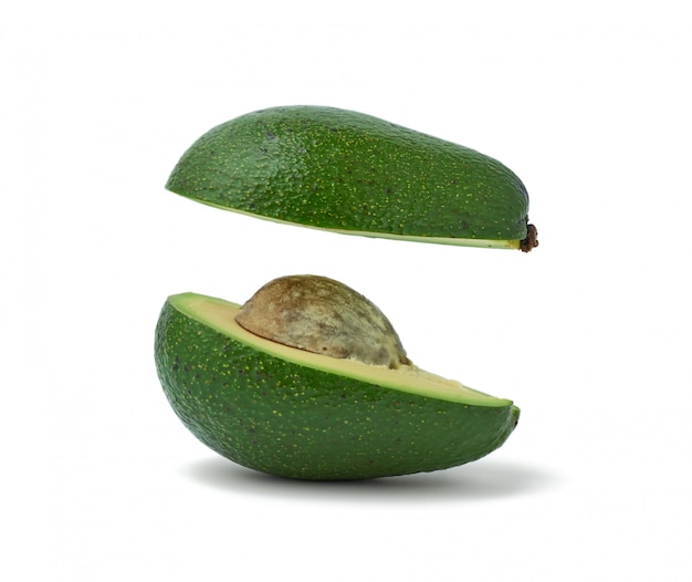 Cut ripe green avocado with a bone isolated on a white background