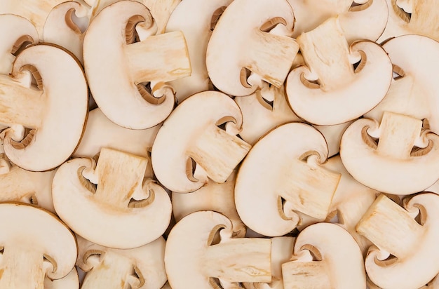 Cut slices of champignon mushrooms. Close-up background texture