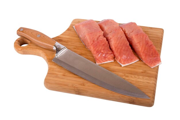 Cut slices of fish Siberian salmon on kitchen board and knife isolated on white background