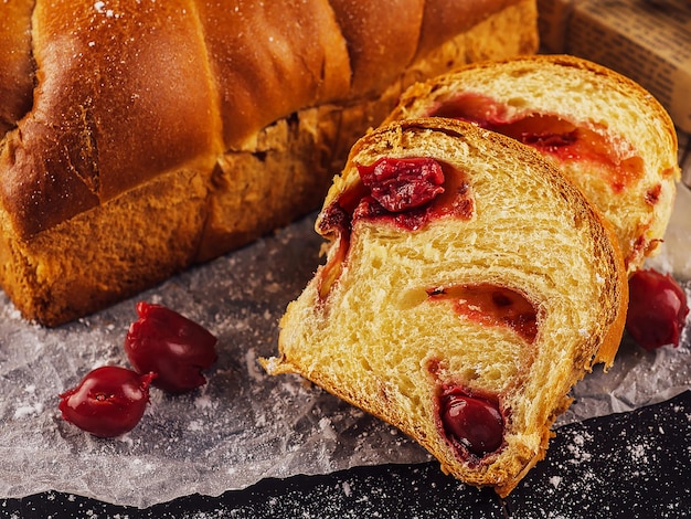 Cut sweet twisted bun with cherry