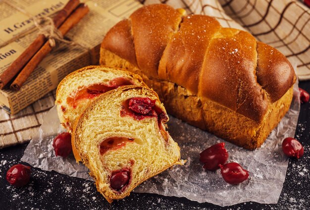 Cut sweet twisted bun with cherry