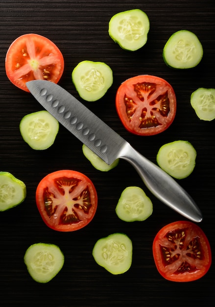 Cut tomato and cucumber with a knife