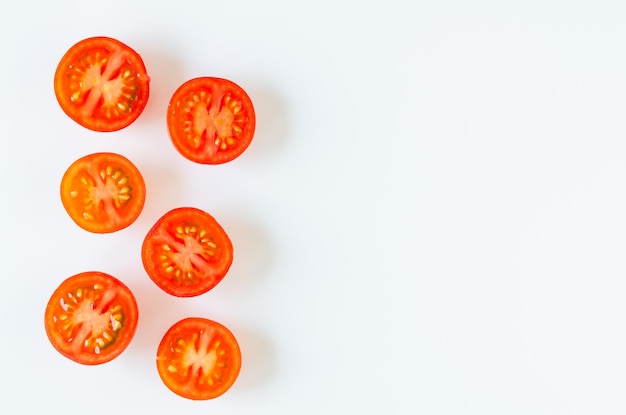 Cut tomatoes on white background