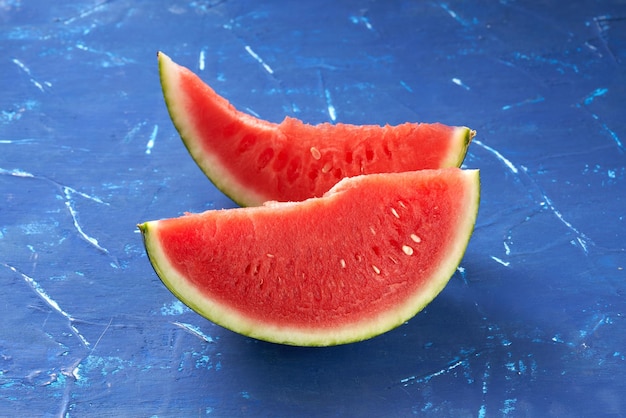 Cut watermelon on blue background