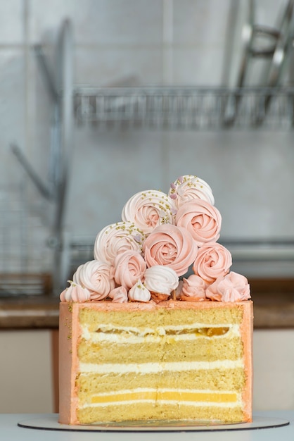 Cutaway sponge cake. Peach-colored cake decorated with marshmallows.