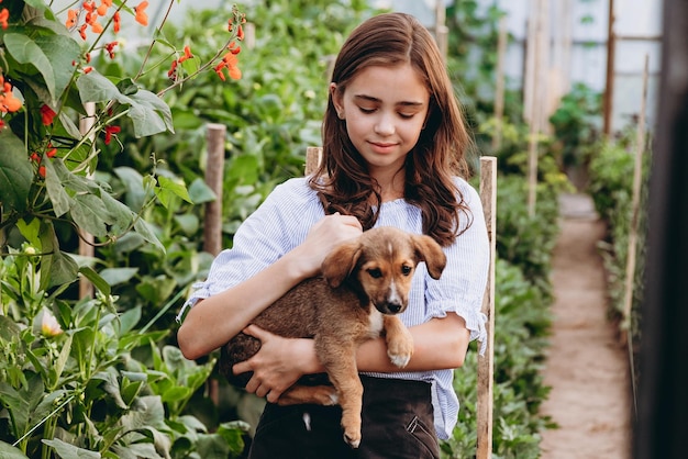 Cute 13yearold child girl carrying basket of beautiful flower in the flower field with happiness