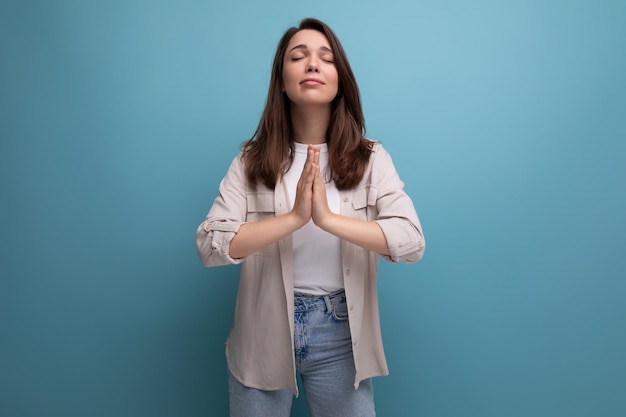 cute 25 year old female person in casual look hope for the best on blue background