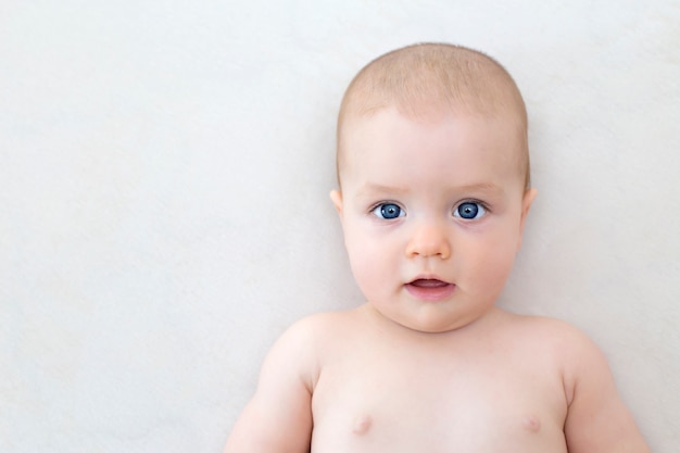 Cute adorable baby girl lying on the bed