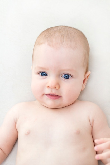 Cute adorable baby girl lying on the bed