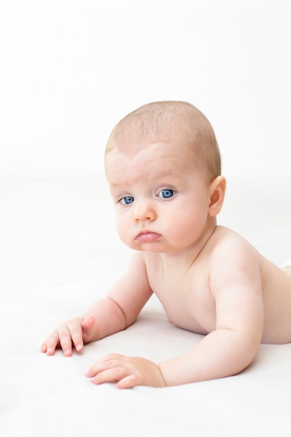 Cute adorable baby girl lying on the bed