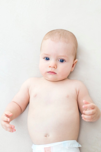 Cute adorable baby girl lying on the bed