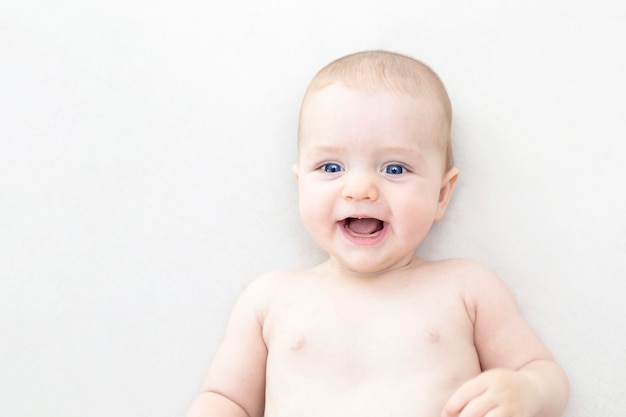 Cute adorable baby girl lying on the bed